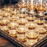stylish-glasses-with-cognac-or-whiskey-on-table-at-wedding-reception-alcohol-bar-tasty-drinks-for-celebrations-and-events-113687561